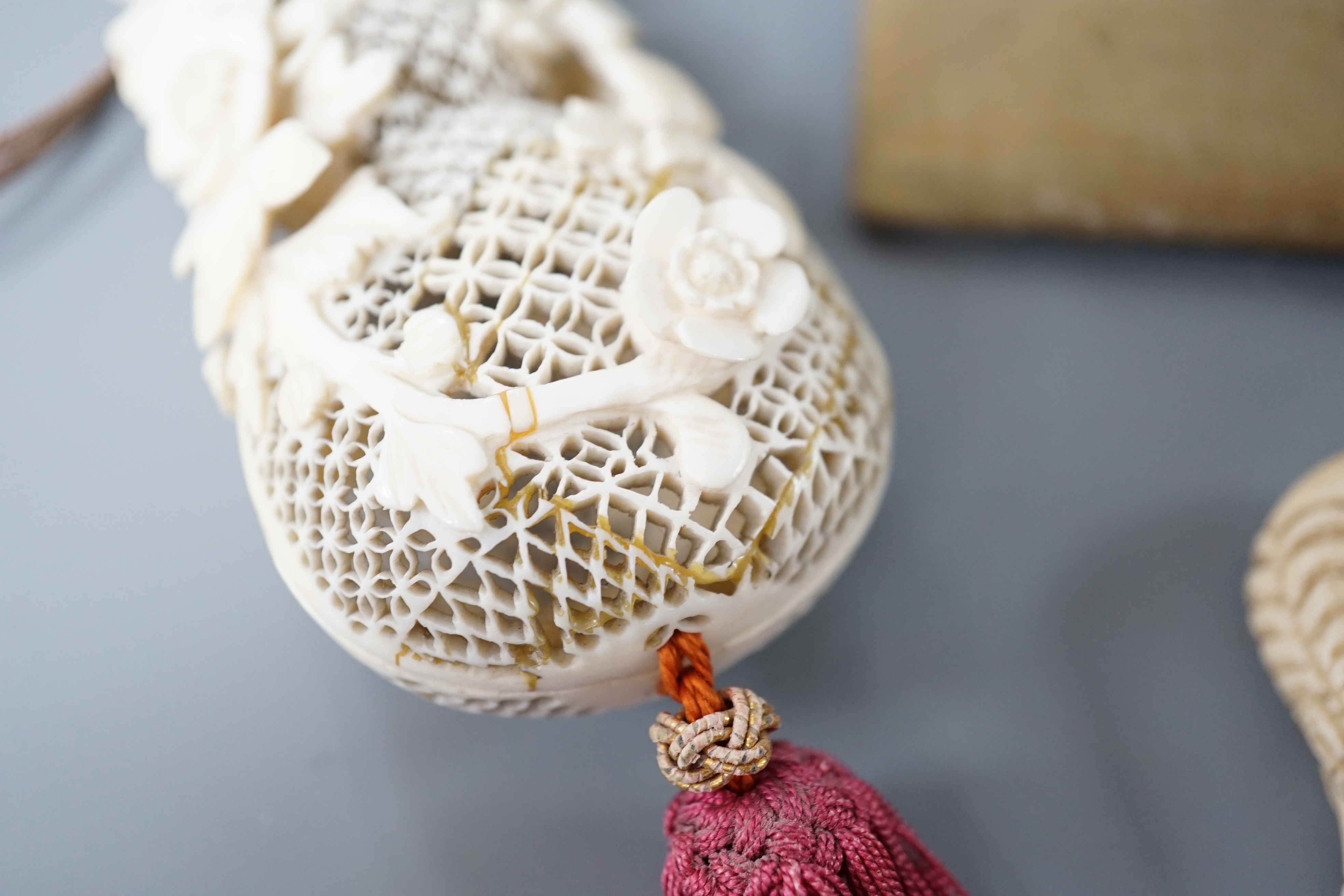 A 19th century Chinese pierced Ivory scent box together with a netsuke modelled as a horse and ivory pierced panel (3)